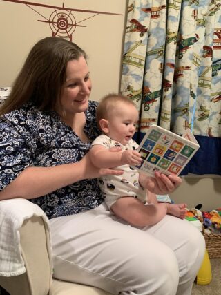 Sarah Adams, former Archway Professional in Colquitt County, reads a book to her infant son